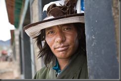 Sotse 30 Yak herder. Many of the nomad men wear the signs tobacco snuff under their nose.