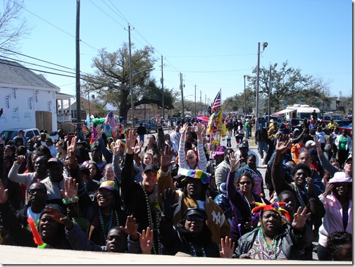 the crowd screaming for beads